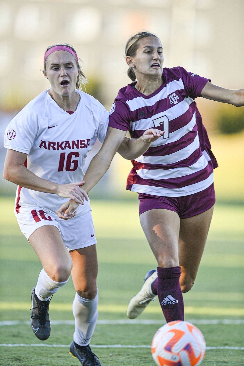 Arkansas’ Anna Podojil (left) and Texas A&M’s Katie Smith jockey for position Thursday to try to control the ball during the No. 12 Razorbacks’ game against the Aggies at Razorback Field in Fayetteville. Podojil scored with 18 seconds left in the first half to give Arkansas a 1-0 victory.
(NWA Democrat-Gazette/Hank Layton)