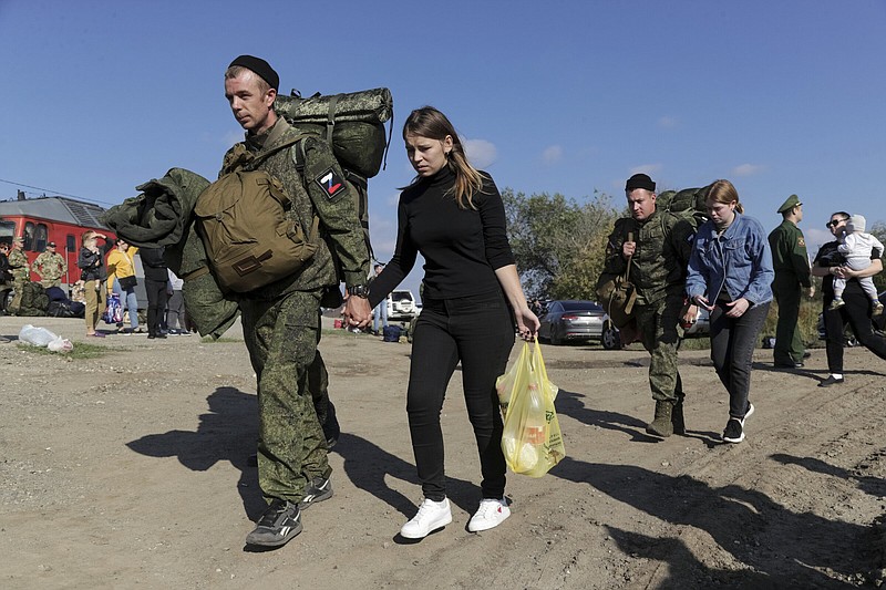 Russian recruits escorted by their wifes walk to take a train at a railway station Thursday in Prudboi, Volgograd region of Russia. Russian President Vladimir Putin has ordered a partial mobilization of reservists to beef up his forces in Ukraine. More photos at arkansasonline.com/ukrainemonth8/.
(AP)