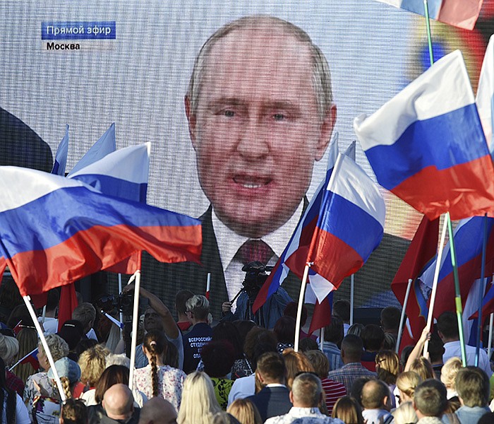 People in Sevastopol, Crimea, watch on a large screen Friday as Russian President Vladimir Putin delivers a speech from the Kremlin in Moscow after a ceremony to sign the treaties for four regions of Ukraine to join Russia. More photos at arkansasonline.com/101moscow/.
(AP)