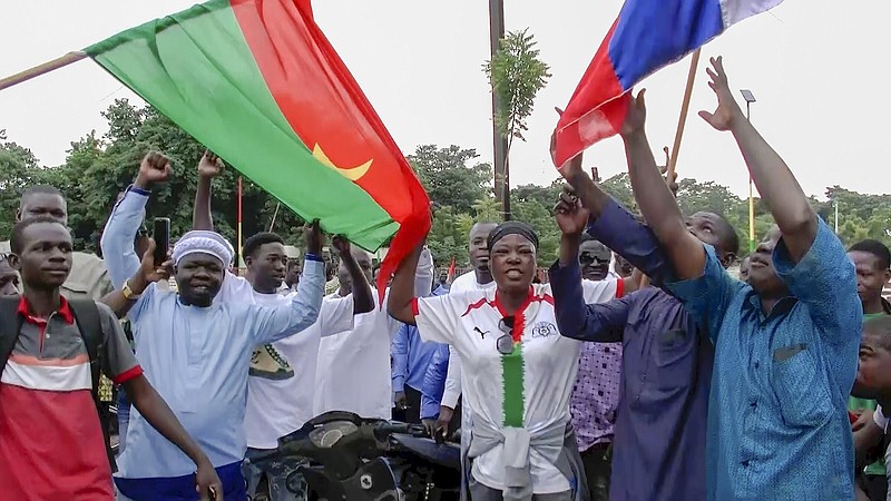 Demonstrators gather near Thomas Sankara memorial Friday with Burkina Faso and Russian flags in support of what they believe to be another military coup in Ouagadougou. Video at arkansasonline.com/101traore/
(AP)