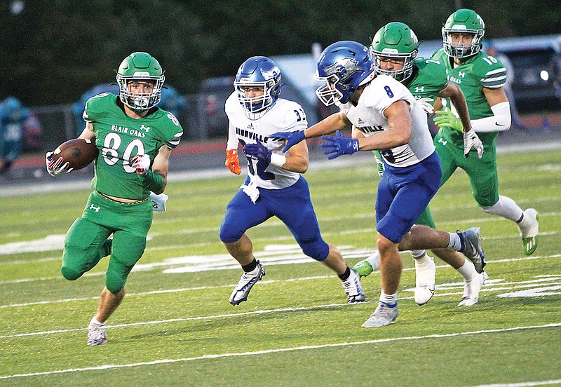 Blair Oaks wide receiver Nick Closser is chased by Boonville’s Eli Stock (32) and Rhodes Leonard (8) during last Friday night’s game at the Falcon Athletic Complex in Wardsville. (Gracen Gaskins/News Tribune)