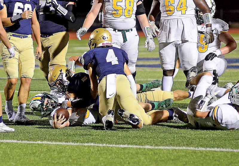 Helias defenders, including Maddox Alfultis (4), combine to bring down Cooper Myers of Rock Bridge during last Friday night’s game at Ray Hentges Stadium. (Eileen Wisniowicz/News Tribune)