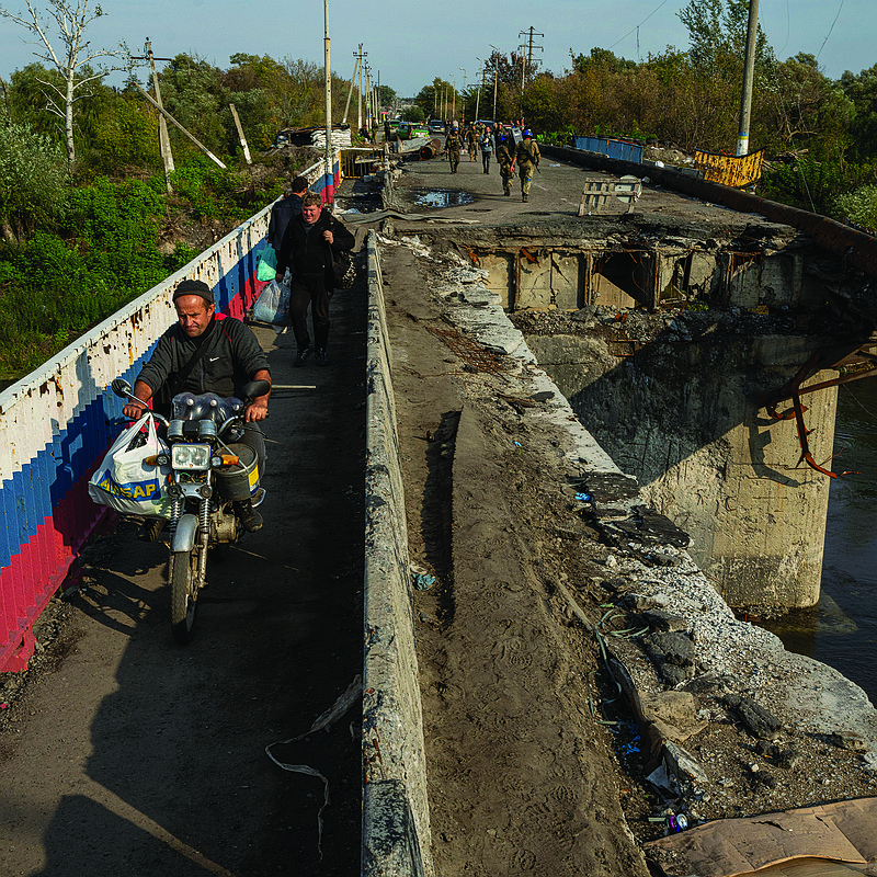 A man drives a motorbike on a destroyed bridge across the Oskil River on Saturday during an evacuation in the recently liberated town of Kupiansk, Ukraine. More photos at arkansasonline.com/ukrainemonth8/.
(AP/Evgeniy Maloletka)
