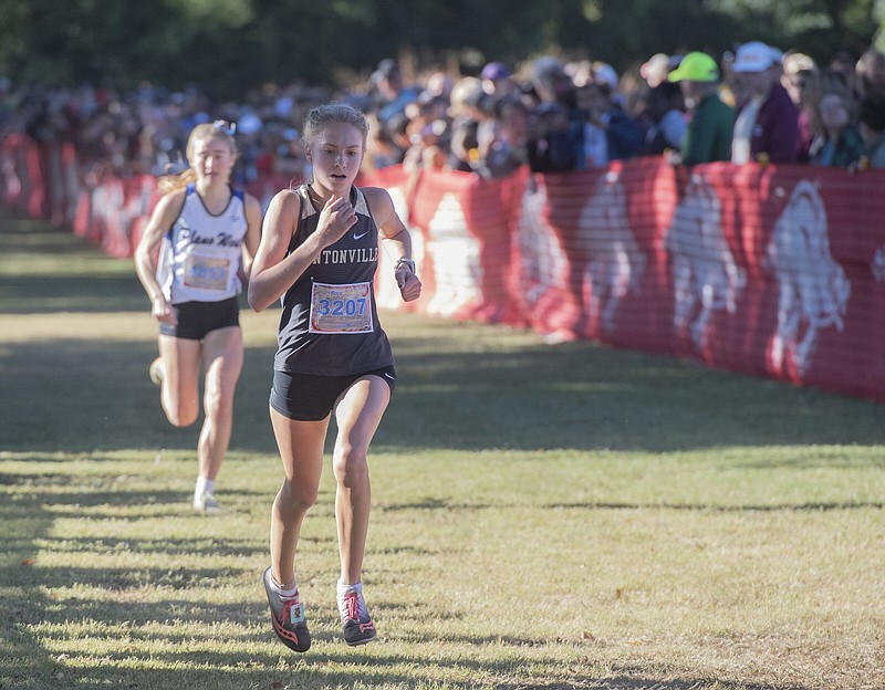 Bentonville junior Haley Loewe (right) finished first in the senior high girls’ “El Caliente” varsity 5K race Saturday during the 34th annual Chile Pepper Festival in Fayetteville. Loewe turned in a personal best 17:20.5.
(NWA Democrat-Gazette/J.T. Wampler)