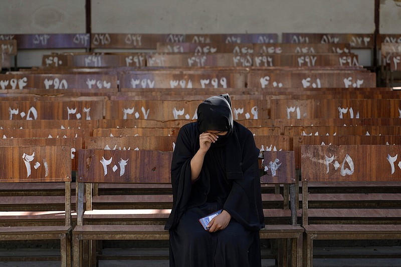 A 19-year old Hazara Afghan girl sits and cries on the bench she was sitting on, during Friday's suicide bomber attack on a Hazara education center, in Kabul, Afghanistan, Saturday, Oct. 1, 2022. (AP/Ebrahim Noroozi)