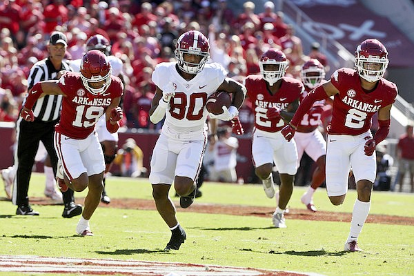 Alabama receiver Kobe Prentice (80) breaks away from Arkansas defenders, Khari Johnson (19), Chris Paul Jr. (27) and Myles Slusher (2) on his way to score a touchdown during the first half of an NCAA college football game Saturday, Oct. 1, 2022, in Fayetteville. (AP Photo/Michael Woods)