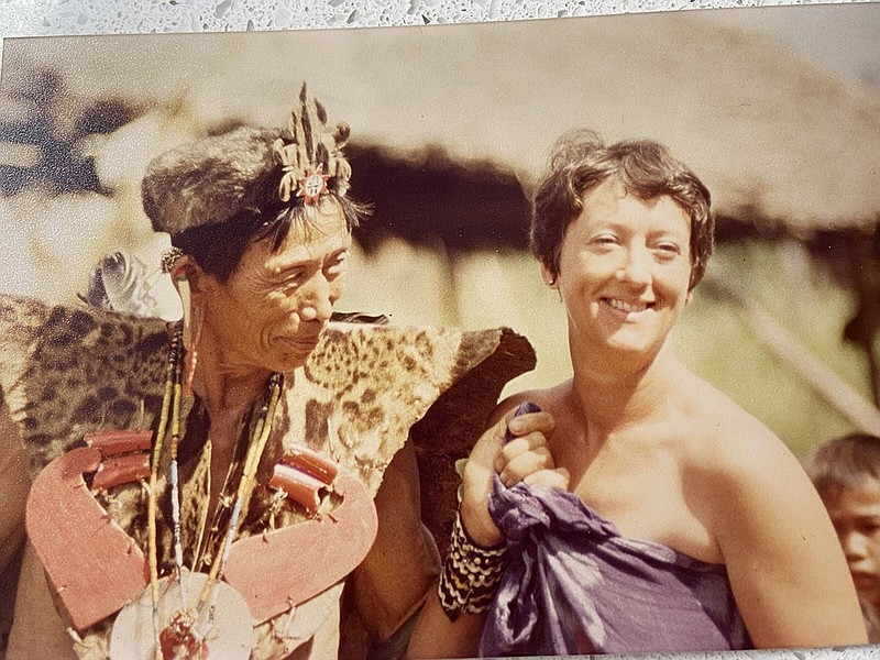 Sandi Villinski went with some other expatriates to visit villages of Irian Jaya, Indonesia. She is pictured here with a village chief who welcomed them to a celebration in his village.
(Special to the Democrat-Gazette)