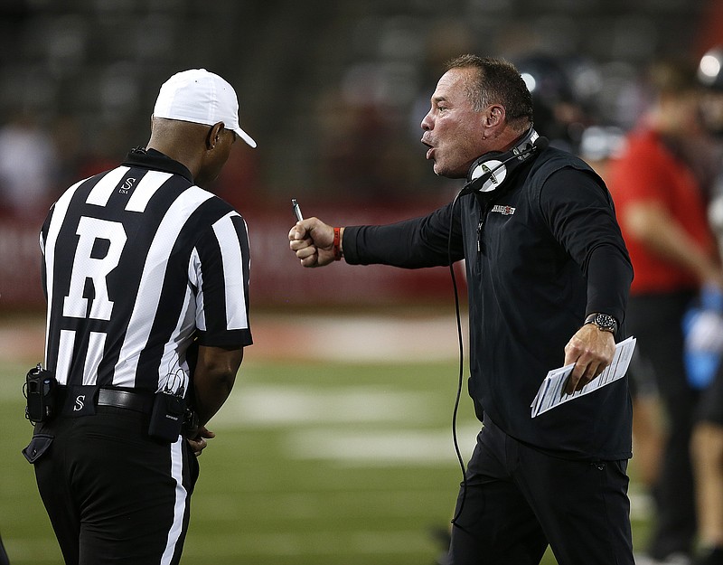 FILE — Arkansas State head coach Butch Jones discusses a call with referee Tennis Livingston during the fourth quarter of the Red Wolves' 45-28 win on Saturday, Oct. 1, 2022, at Centennial Bank Stadium in Jonesboro. (Arkansas Democrat-Gazette/Thomas Metthe)