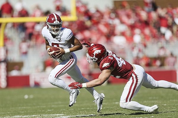 Arkansas linebacker Drew Sanders tackles Alabama quarterback Bryce Young during a game Saturday, Oct. 1, 2022, in Fayetteville.