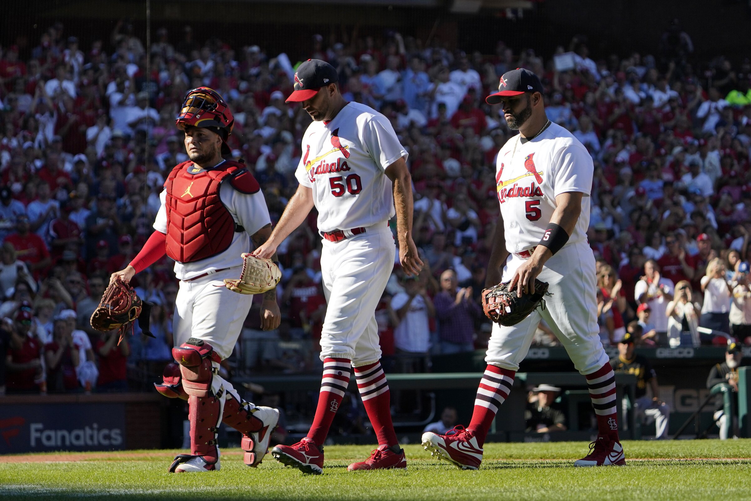 St. Louis Cardinals' Yadier Molina (4) gets a hug from former