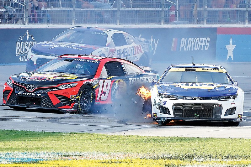 Chase Elliott has his tire catch fire as Martin Truex Jr. (19) and Corey LaJoie (7) drive past during last Sunday’s NASCAR Cup Series race at Texas Motor Speedway in Fort Worth, Texas. (Associated Press)