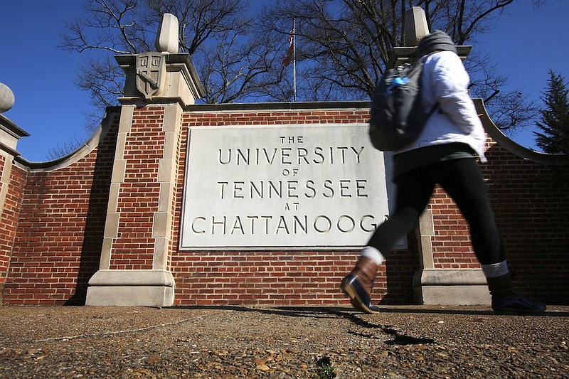 Staff photo / A student walks past a University of Tennessee at Chattanooga sign along McCallie Avenue on Jan. 28, 2019, in Chattanooga.