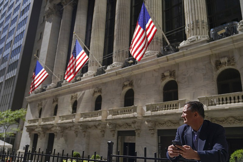 FILE - A trader stands outside the New York Stock Exchange, Friday, Sept. 23, 2022, in New York.   (AP Photo/Mary Altaffer)