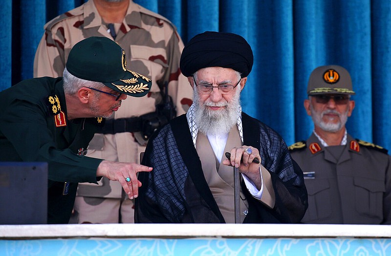 In this picture released by the official website of the office of the Iranian supreme leader, Supreme Leader Ayatollah Ali Khamenei, center, listens to chief of the General Staff of the Armed Forces Gen. Mohammad Hossein Bagheri at a graduation ceremony for a group of armed forces cadets at the police academy in Tehran, Iran, Monday, Oct. 3, 2022. Khamenei responded publicly on Monday to the biggest protests in Iran in years, breaking weeks of silence to condemn what he called â€œriotingâ€ and accuse the U.S. and Israel of planning the protests. (Office of the Iranian Supreme Leader via AP)