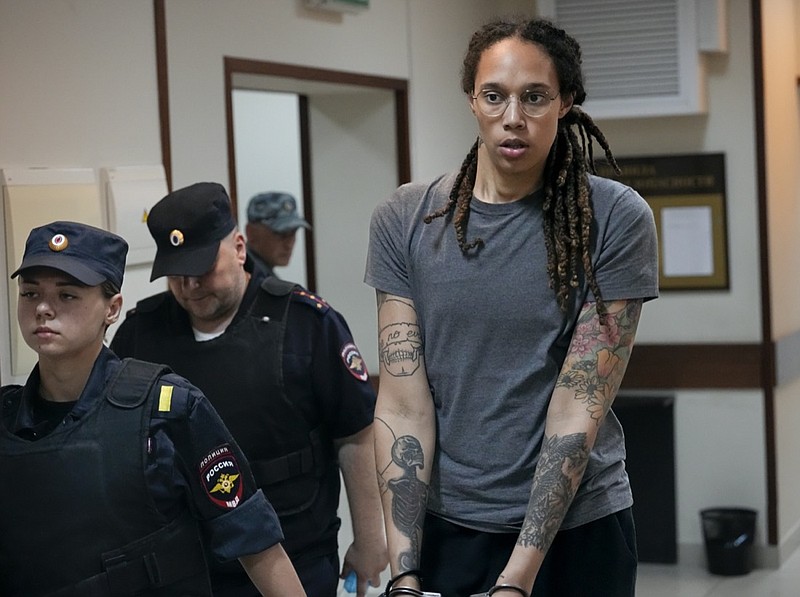 FILE - WNBA star and two-time Olympic gold medalist Brittney Griner is escorted from a courtroom after a hearing in Khimki just outside Moscow, Russia, on Aug. 4, 2022. The Moscow region's court on Monday Oct. 3, 2022 set a date for American basketball star Brittney Griner's appeal against her nine-year prison sentence for drug possession, scheduling the hearing for Oct. 25. (AP Photo/Alexander Zemlianichenko, File)