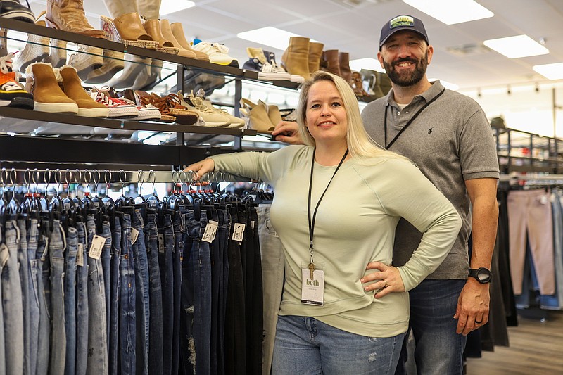 Staff photo by Olivia Ross  / Owners Mitchell and Beth Savini pose for a photo at Uptown Cheapskate on October 4, 2022. Uptown Cheapskate, located in Hixson, is an upscale resale shop. The store buys and sells gently used apparel and accessories.