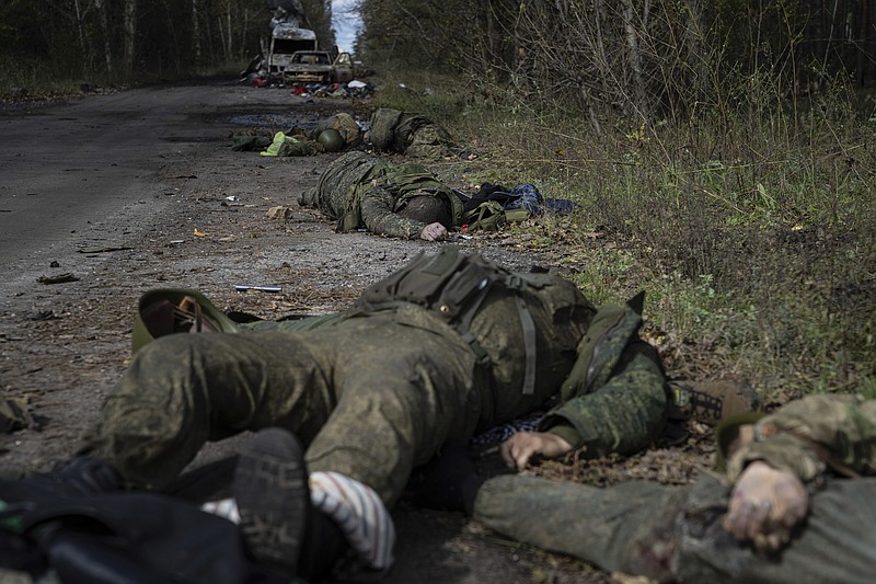 Dead bodies of Russian servicemen lie on the ground in recently recaptured town of Lyman, Ukraine, Monday, Oct. 3, 2022. (AP Photo/Evgeniy Maloletka)