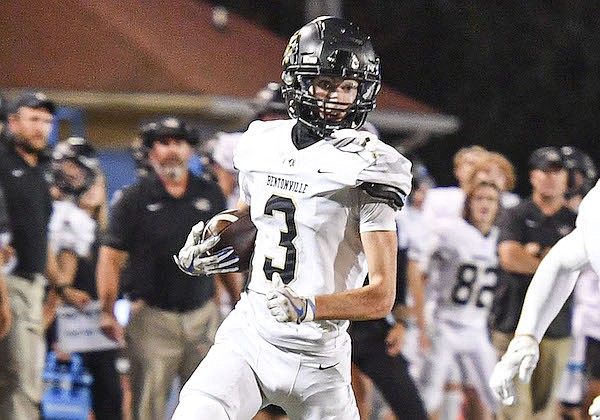 Bentonville defensive back JT Tomescko (3) returns an interception as teammate Johny Pike (24) blocks, Friday, Sept. 30, 2022, during the fourth quarter of the Tigers’ 48-14 win over Fort Smith Southside at Jim Rowland Stadium in Fort Smith.