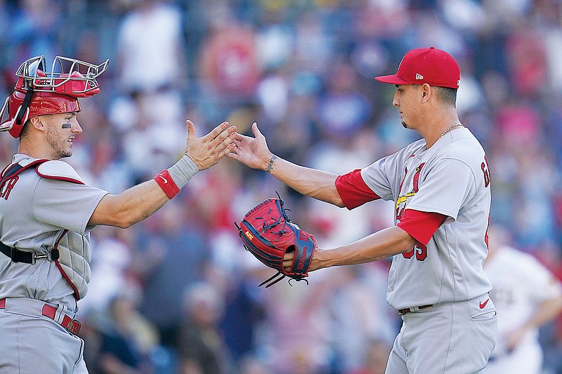 Giovanny Gallegos celebrates with Cardinals catcher Andrew Knizner after a win last month against the Padres in San Diego. (Associated Press)