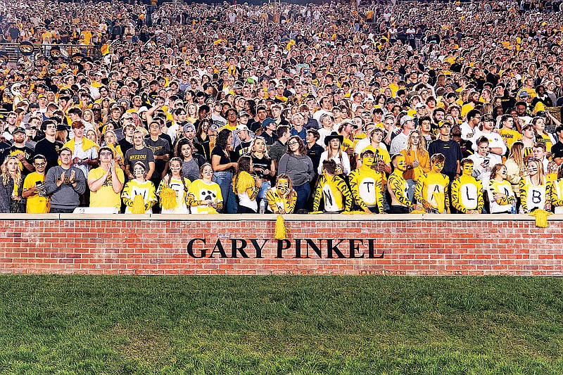 Missouri fans cheer Saturday night behind the newly revealed Gary Pinkel addition to the ring of honor at Faurot Field in Columbia. (Associated Press)