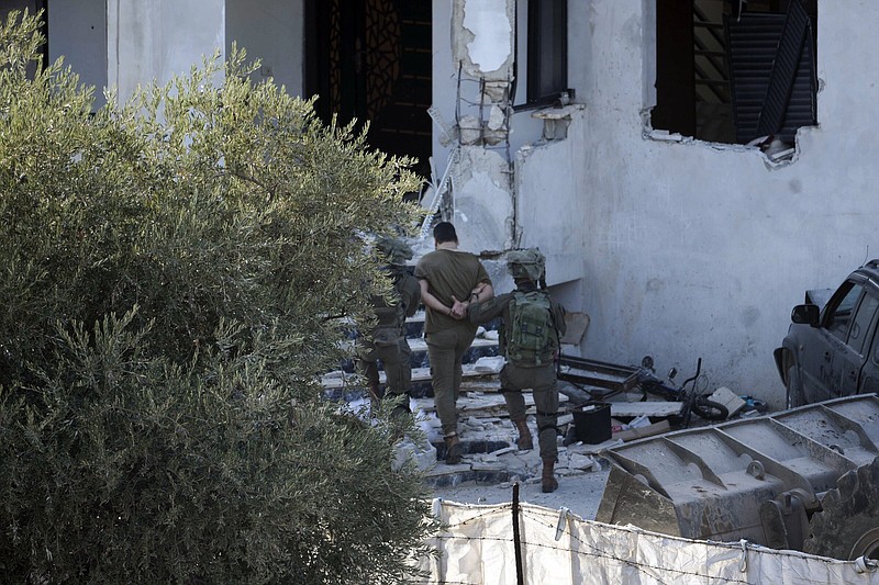 Israeli soldiers arrest a Palestinian man Wednesday during a raid in the village of Deir al-Hatab near the West Bank city of Nablus.
(AP/Majdi Mohammed)