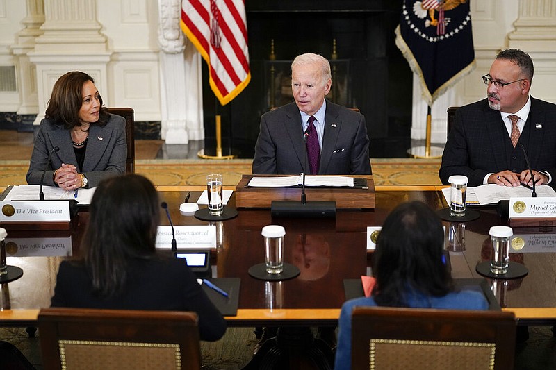 President Joe Biden speaks during a meeting of the reproductive rights task force in the State Dining Room of the White House in Washington, Tuesday, Oct. 4, 2022. Vice President Kamala Harris, left, and Education Secretary Miguel Cardona, right, listen. (AP Photo/Susan Walsh)