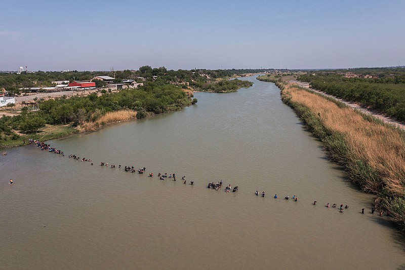 A large group of immigrants crosses the Rio Grande into Eagle Pass, Texas, in May. Despite record numbers of arrivals in recent months, border stations right now are largely free of such chaotic scenes.
(The New York Times/Tamir Kalifa)