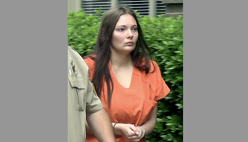 FILE — Dayla Diane Ferrer is escorted into the Garland County Court House for her arraignment in this May file photo. (Hot Springs Sentinel-Record)
