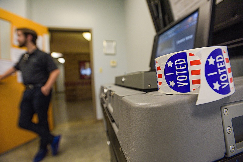 A ballot machine and roll of “I voted” stickers on Tuesday, August 9, 2022, at the Martin Luther King Jr. Park Community Building in Fort Smith. (NWA Democrat-Gazette/Hank Layton)