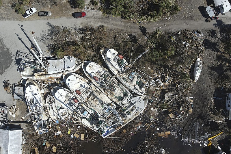 In this photo shot with a drone, a group of shrimp boats is left grounded following the passage of Hurricane Ian, on San Carlos Island in Fort Myers Beach, Fla., Friday, Oct. 7, 2022. (AP Photo/Rebecca Blackwell)