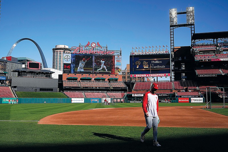 Bryce Harper of the Phillies walks off the field during baseball practice Thursday at Busch Stadium in St. Louis. Harper and the Phillies will take on the Cardinals in Game 1 of a National League Wild-Card series this afternoon.  (Associated Press)