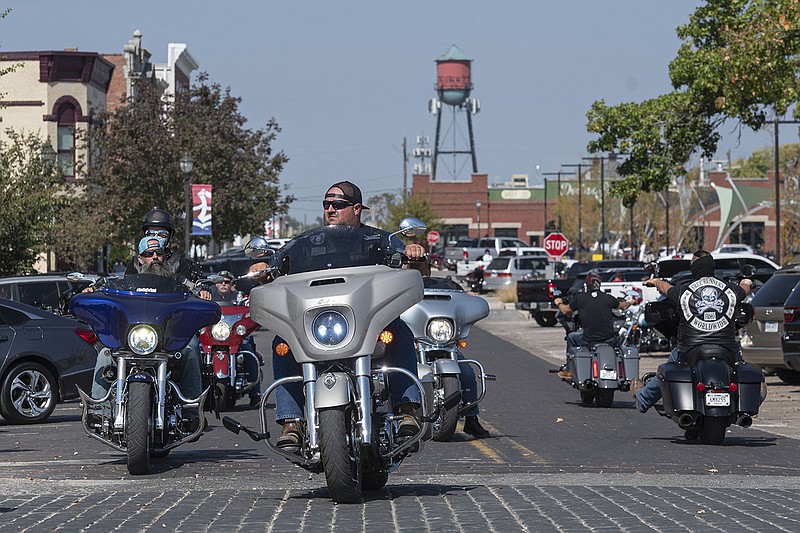Motorcyclists ride down First Street in downtown Rogers during Bikes, Blues and BBQ on Friday, Oct. 7, 2022. (NWA Democrat-Gazette/Spencer Tirey)