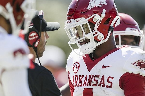 Arkansas quarterback Malik Hornsby (right) speaks with offensive coordinator Kendal Briles during a game against Mississippi State on Saturday, Oct. 8, 2022, in Starkville, Miss.