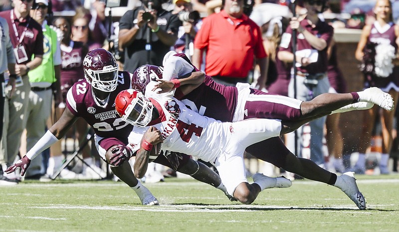 Arkansas quarterback Malik Hornsby (4) takes a sack, Saturday, October 8, 2022 during the fourth quarter of a football game at Davis Wade Stadium in Starkville. Visit nwaonline.com/221009Daily/ for today's photo gallery...(NWA Democrat-Gazette/Charlie Kaijo)