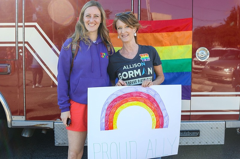 Staff photo by Olivia Ross  / Meg and Allison Gorman pose with a sign Sunday, Oct. 2, 2022, before Chattanooga's Pride Parade. Chattanooga's Pride Parade began at Walnut Street, ending at the Chattanooga Green with food, art, entertainment and more.