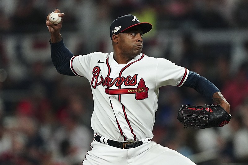 Atlanta Braves relief pitcher Raisel Iglesias (26) works during the eighth inning in Game 2 of baseball's National League Division Series between the Atlanta Braves and the Philadelphia Phillies, Wednesday, Oct. 12, 2022, in Atlanta. (AP Photo/John Bazemore)