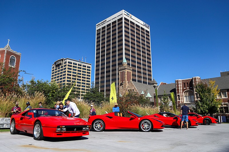 Staff photo by Olivia Ross  / Attendees check out the Gathering of the Greats Ferrari Edition in West Village on Friday, October 14, 2022. The third annual Chattanooga Motorcar Festival returned to Downtown Chattanooga and will run from October 14-16th. .