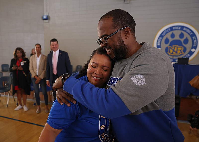 Capri Salaam is embraced by her former principal Quintin Cain after receiving the 2023 Arkansas Teacher of the Year award during an assembly at the North Little Rock Middle School on Friday. Salaam began her teaching career with the North Little Rock School District in 2015 and was one of four semifinalists from across the state for the prestigious award. More photos at arkansasonline.com/1015teacher/.
(Arkansas Democrat-Gazette/Colin Murphey)