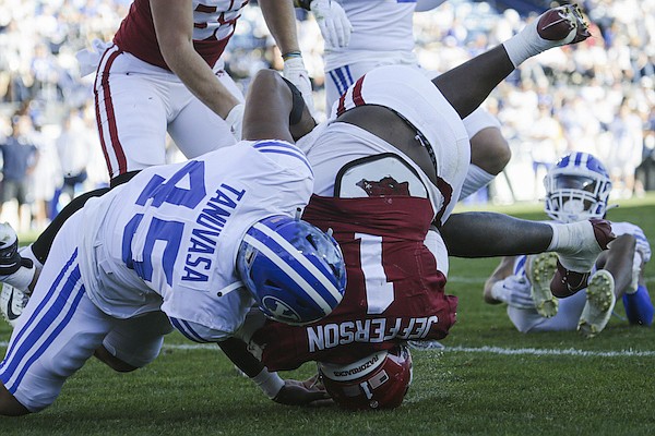 Arkansas quarterback KJ Jefferson (1) lands on his head during a game against BYU on Saturday, Oct. 15, 2022, in Provo, Utah. Arkansas quarterback KJ Jefferson (1) lands on his head during a game against BYU on Saturday, Oct. 15, 2022, in Provo, Utah.