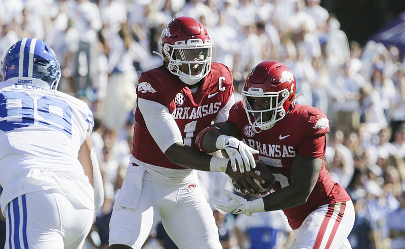 Arkansas quarterback KJ Jefferson (1) hands the ball off to running back Raheim Sanders (5), Saturday, October 15, 2022 during the second quarter of a football game at LaVell Edwards Stadium in Provo, Utah. Visit nwaonline.com/221016Daily/ for today's photo gallery...(NWA Democrat-Gazette/Charlie Kaijo)