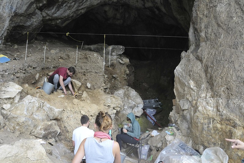 In this photo provided by Bence Viola in October 2022, researchers excavate a cave in the mountains of Siberia, Russia. In a studypublished Wednesday, Oct. 19, 2022, in the journal Nature, researchers were able to pull DNA out of tiny bone fragments found in two Russian caves, and used the genetic data to map out relationships between 13 different Neanderthals for clues to how they lived. (Bence Viola via AP)