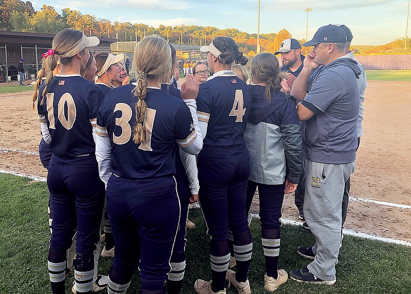 The Helias Lady Crusader players and coaching staff meet after Wednesday's 4-2 win against the Camdenton Lady Lakers in a Class 4 quarterfinal game in Camdenton. (Tom Rackers/News Tribune)
