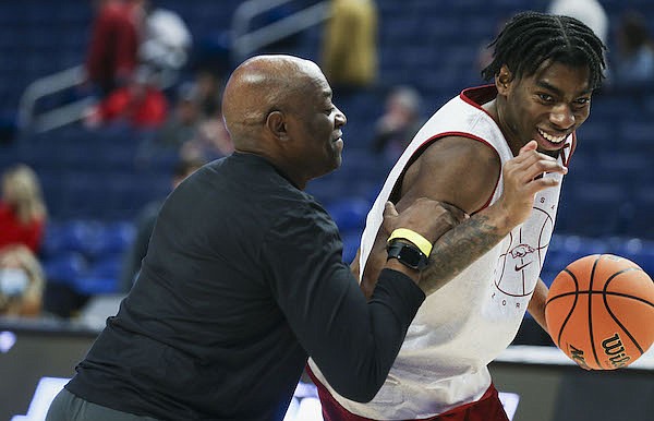 Arkansas assistant coach Keith Smart practices with forward Kamani Johnson on Wednesday, March 16, 2022, during a practice before the first round of the 2022 NCAA Division I Men's Basketball Championship at KeyBank Center in Buffalo, N.Y.