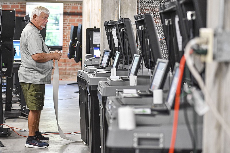 Richard Bracken, a troubleshooter for the Sebastian County Election Commission, tests voting machines, Wednesday, Oct. 12, 2022, at the commission’s office in downtown Fort Smith. (NWA Democrat-Gazette/Hank Layton)