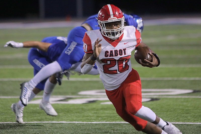 Cabot's Evion Jimmerson (20) evades Bryant's JT Allen (48) during their game Friday Oct. 21, 2022 in Bryant. .More photos at arkansasonline.com/1022bryant/..Stephen B. Thornton/Special to the Arkansas Democrat-Gazette.