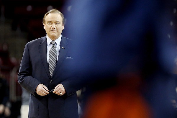 Sportscaster Tim Brando watches as players warm up before the start of an NCAA college basketball game between Virginia and Boston College in Boston, Wednesday, Jan. 18, 2017. (AP Photo/Mary Schwalm)
