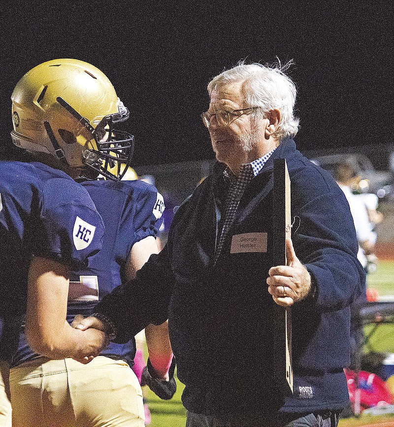 George Heisler shakes hands with Helias lineman Devin Jaegers during halftime of Friday night’s game against Vianney at Ray Hentges Stadium. (Kate Cassady/News Tribune)