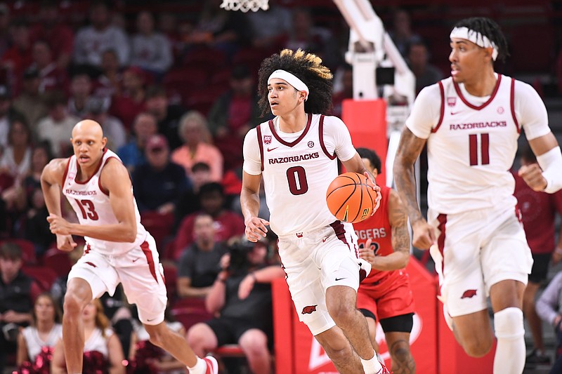 Arkansas guard Anthony Black (0) dribbles the ball in transition as Jordan Walsh (left) and Jalen Graham (right) run alongside him during the Razorbacks' exhibition against Rogers (Okla.) State on Oct. 24, 2022, at Bud Walton Arena in Fayetteville.