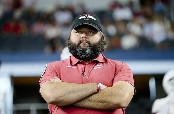 Arkansas offensive line coach Cody Kennedy watches warmups prior to a game against Texas A&M on Saturday, Sept. 24, 2022, in Arlington, Texas.