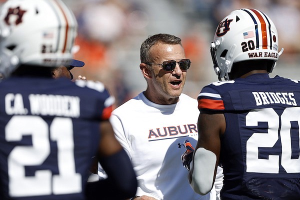 Auburn head coach Bryan Harsin talks with players during warm ups before the start of an NCAA college football game between Auburn and Missouri Saturday, Sept. 24, 2022 in Auburn, Ala. (AP Photo/Butch Dill)